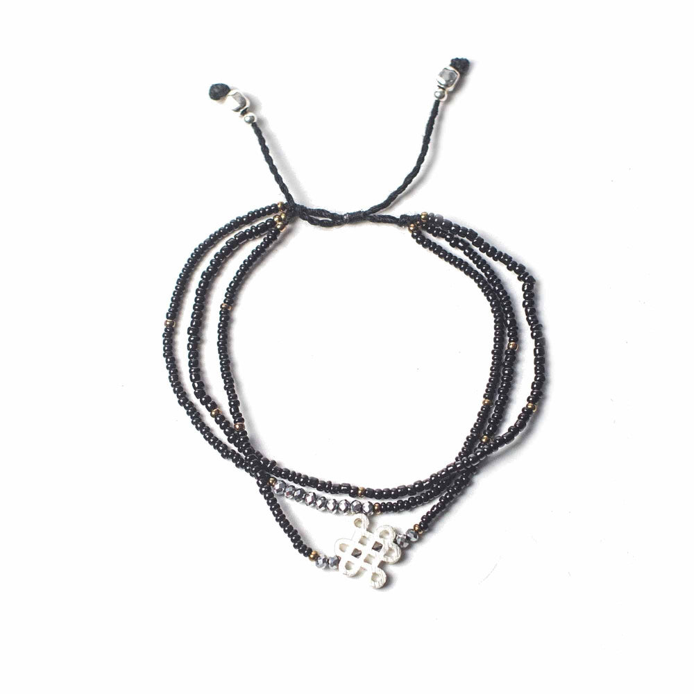 Multistrand beaded bracelet with a clasp on a white background