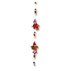 Decorative hanging with small gnome figures on a white background