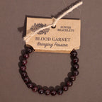 Blood garnet bracelet on a brown background with a label