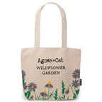Beige tote bag with floral designs and 'Agnes + Cat Wildflower Garden' text on a white background