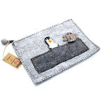 Gray felt pouch with penguin and bear design on a white background