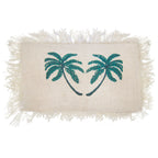 Rectangular white cushion cover with teal palm tree design and fringes on a white background