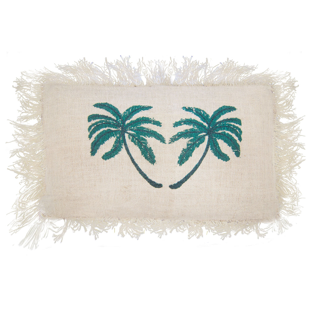 Rectangular white cushion cover with teal palm tree design and fringes on a white background
