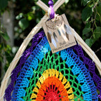Colorful dreamcatcher with a 'Bali Dream Catchers' tag against a natural background.