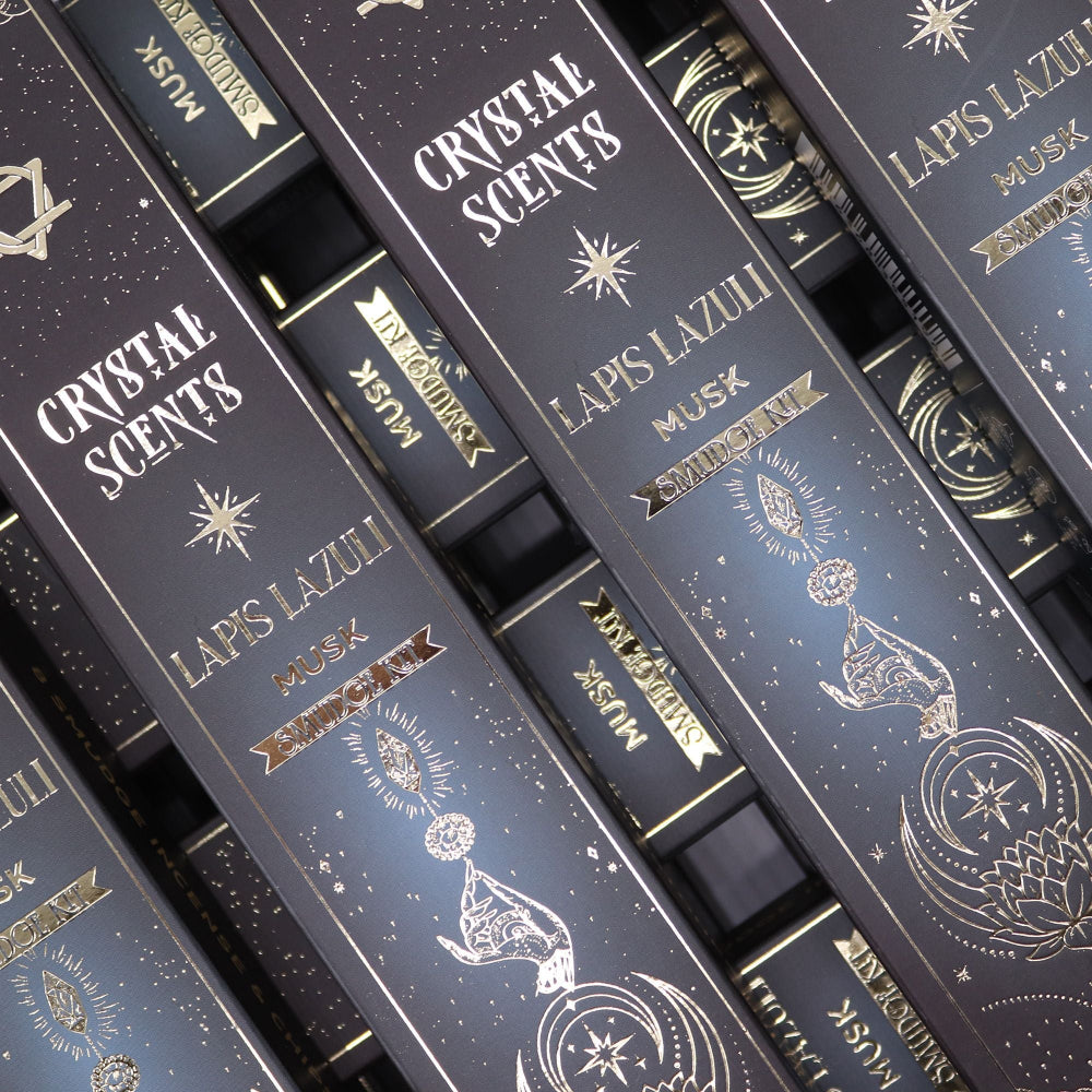 Stack of 'Crystal Scents' Lapis Lazuli Musk packaging with decorative text and symbols.