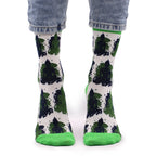 Green and black patterned socks with white background