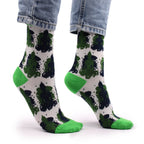Green and black patterned socks with white background