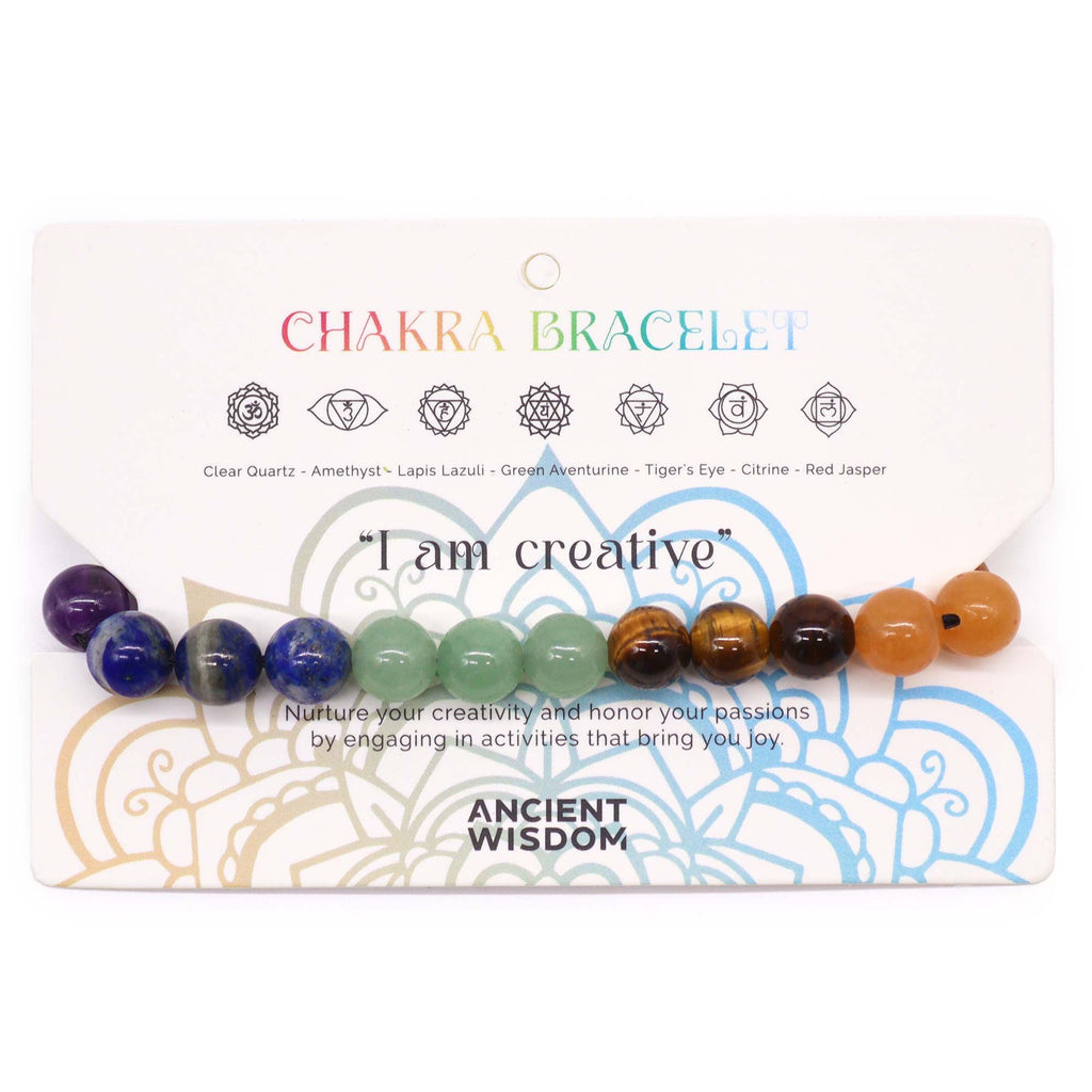 Chakra bracelet with colored beads on a packaging card featuring 'I am creative' text.