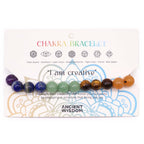 Chakra bracelet with colored beads on a packaging card featuring 'I am creative' text.