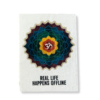 Notebook with a colorful mandala design and 'Real Life Happens Offline' text on a white background