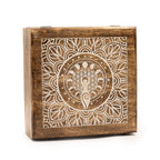 Wooden box with intricate white design on a white background