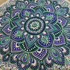 Mandala patterned fabric with green, blue, and white colors.