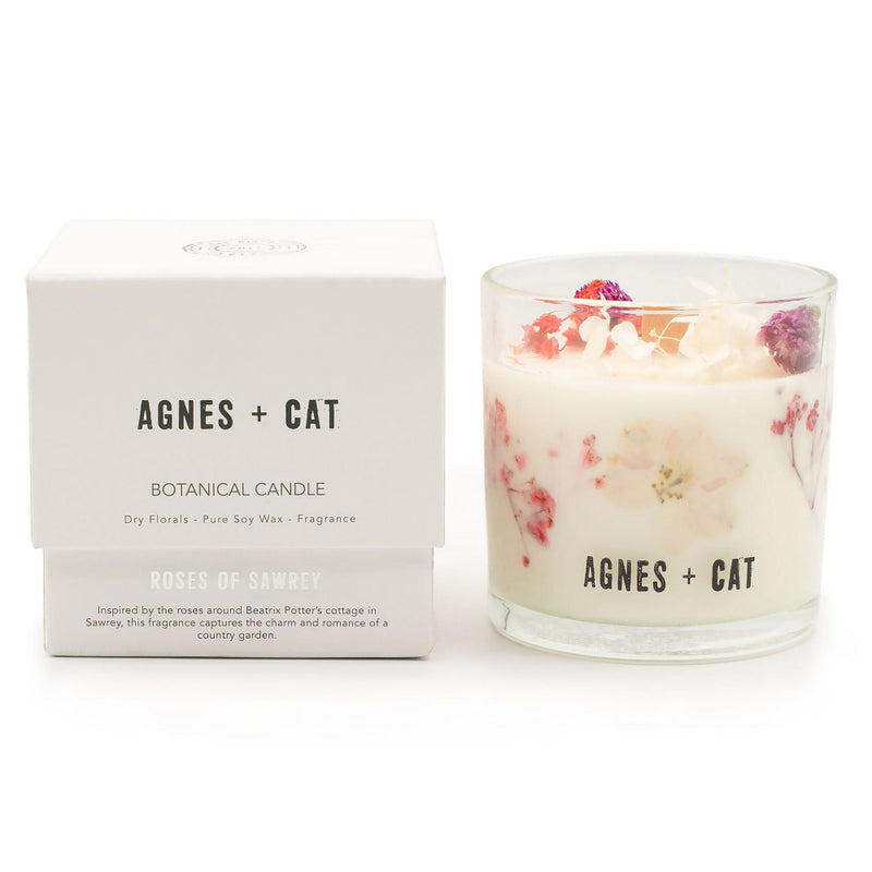 Floral candle with packaging labeled 'Agnes + Cat' on a white background