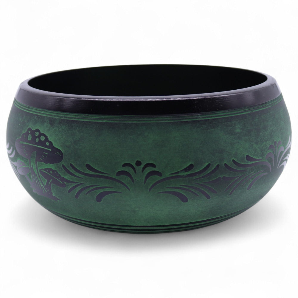 Green ceramic bowl with black interior on a white background