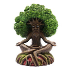 Statue of a tree-like figure with a green head on a white background