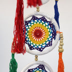 Colorful crocheted dreamcatcher with tassels on a white background
