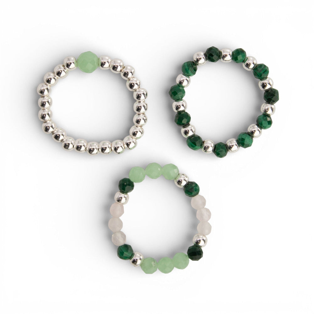 Three beaded rings with green and silver beads on a white background