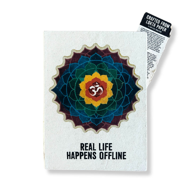 Notebook with a colorful mandala design and 'Real Life Happens Offline' text on a white background.