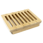Wooden soap dish with slotted design on a white background