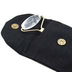 Clear stone roller on a black pouch with gold accents