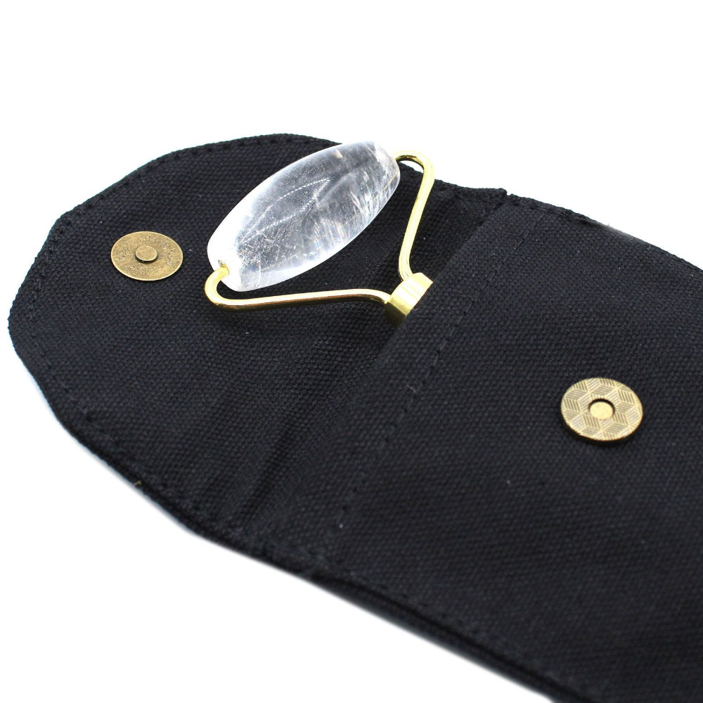 Clear stone roller on a black pouch with gold accents