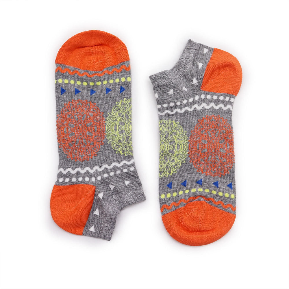 Two pairs of socks with gray, orange, and green patterns on a white background