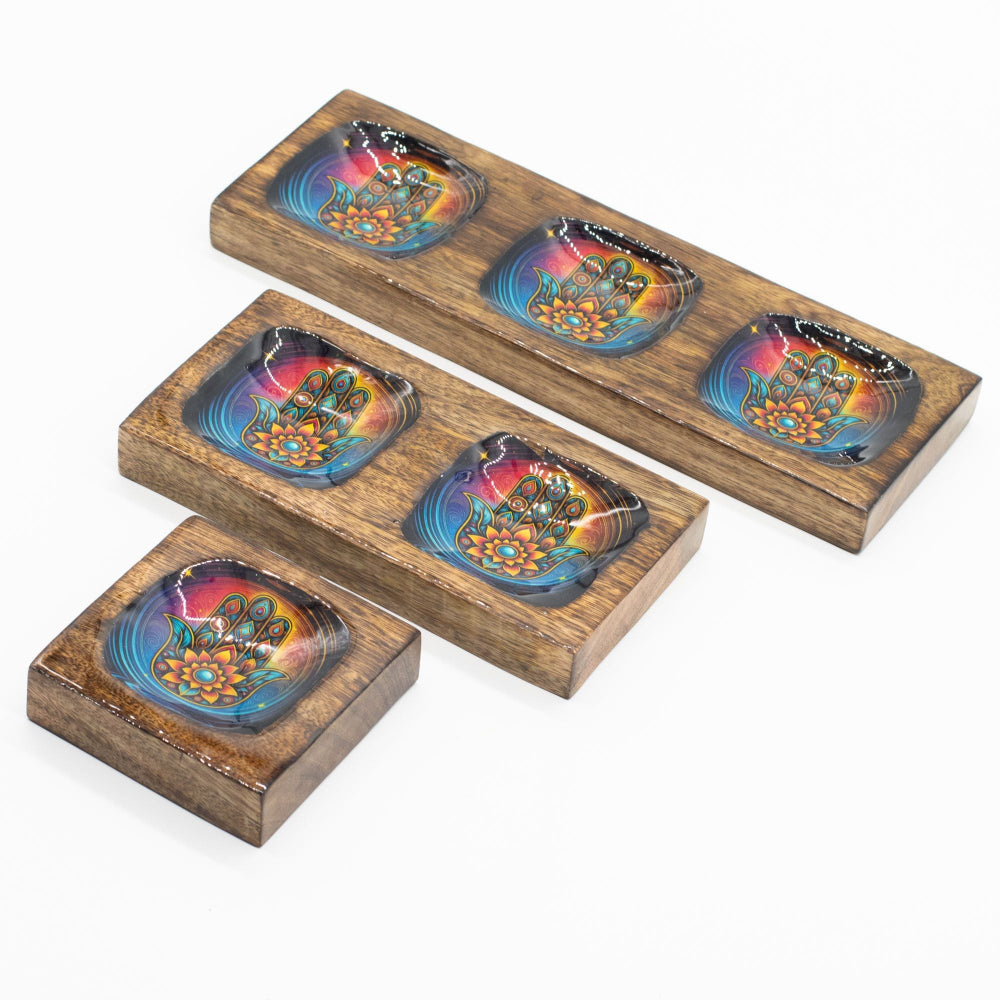 Set of four wooden coasters with colorful designs on a white background