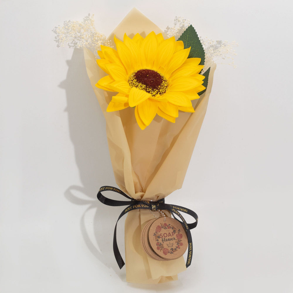 Yellow sunflower wrapped in brown paper with a black ribbon on a white background