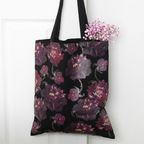 Black tote bag with purple floral pattern on a white background
