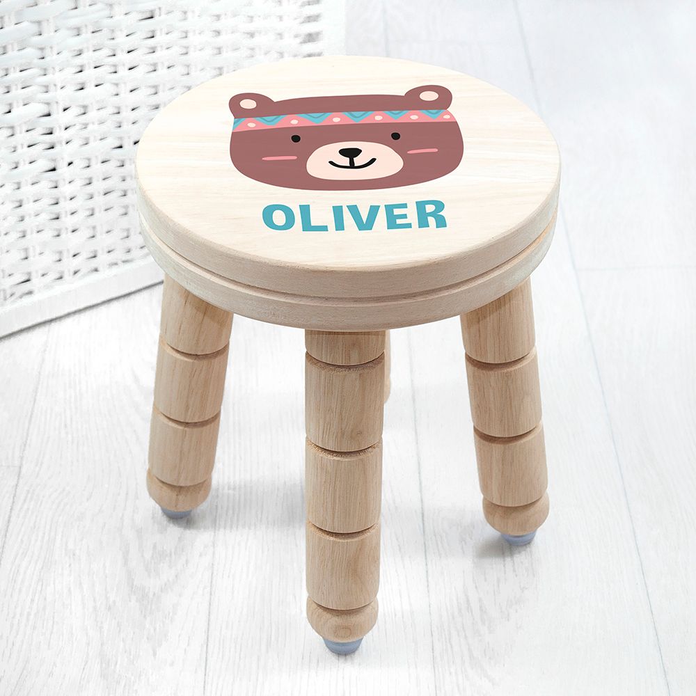 Wooden stool with a bear face design and 'OLIVER' text on a white background